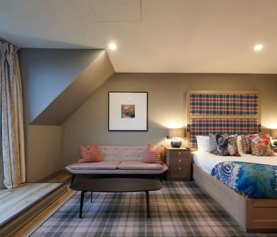 a bed room with a sitting area next to a patio leading to the out side