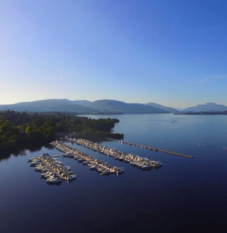 Marina boat slips filled with boats on Loch. Lomond at Cameron House.