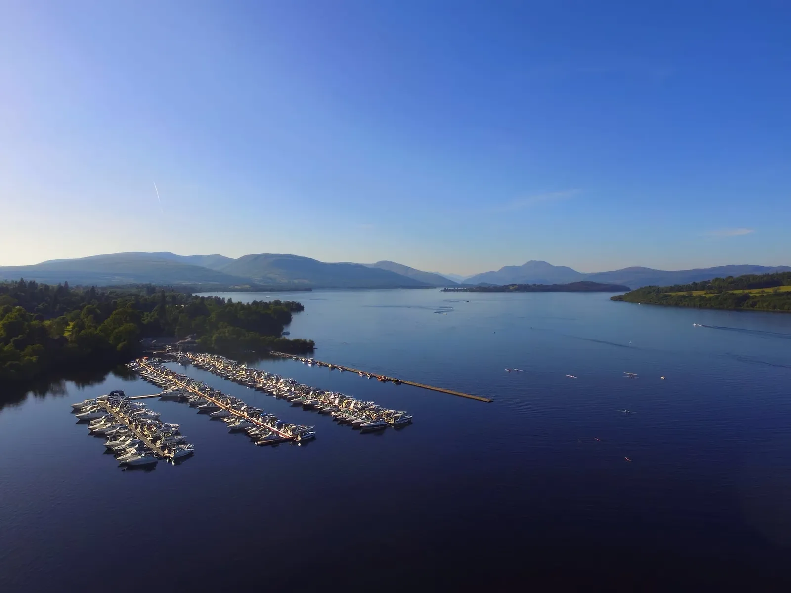 Marina boat slips filled with boats on Loch. Lomond at Cameron House.