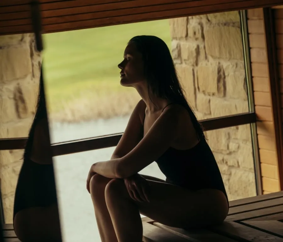 Woman reflecting in the sauna at The Spa at The Carrick