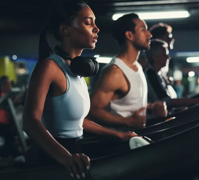 People running on a treadmill in gym