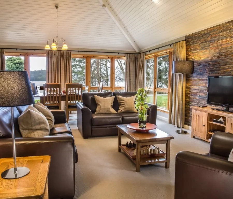 The main living area of the Cameron House two bedroom bungalow, with Loch Lomond visible through the windows.