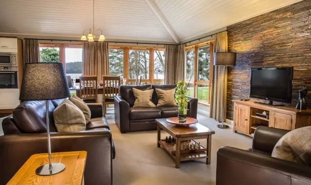 The main living area of the Cameron House two bedroom bungalow, with Loch Lomond visible through the windows.